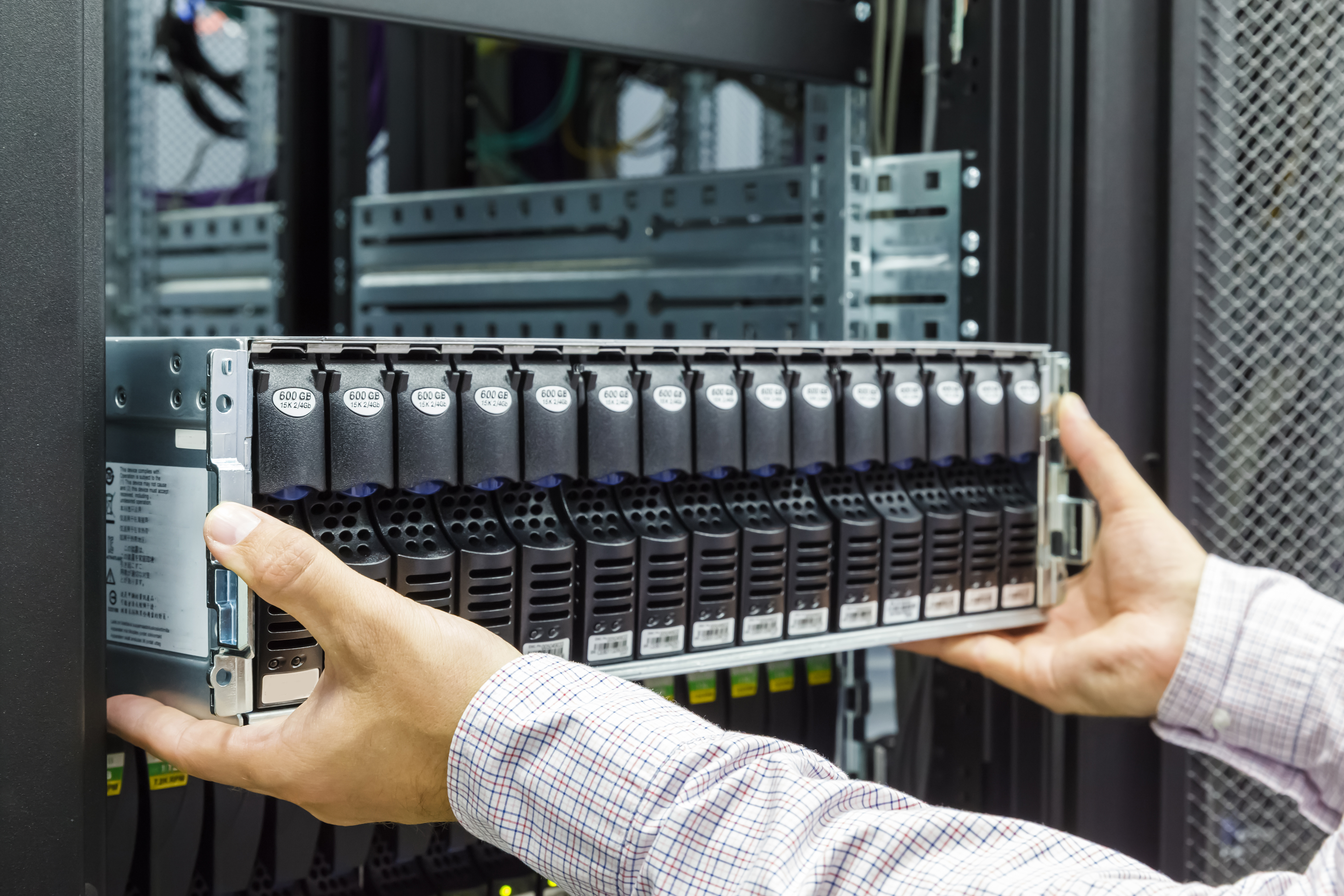 a man pulling out a IT server.