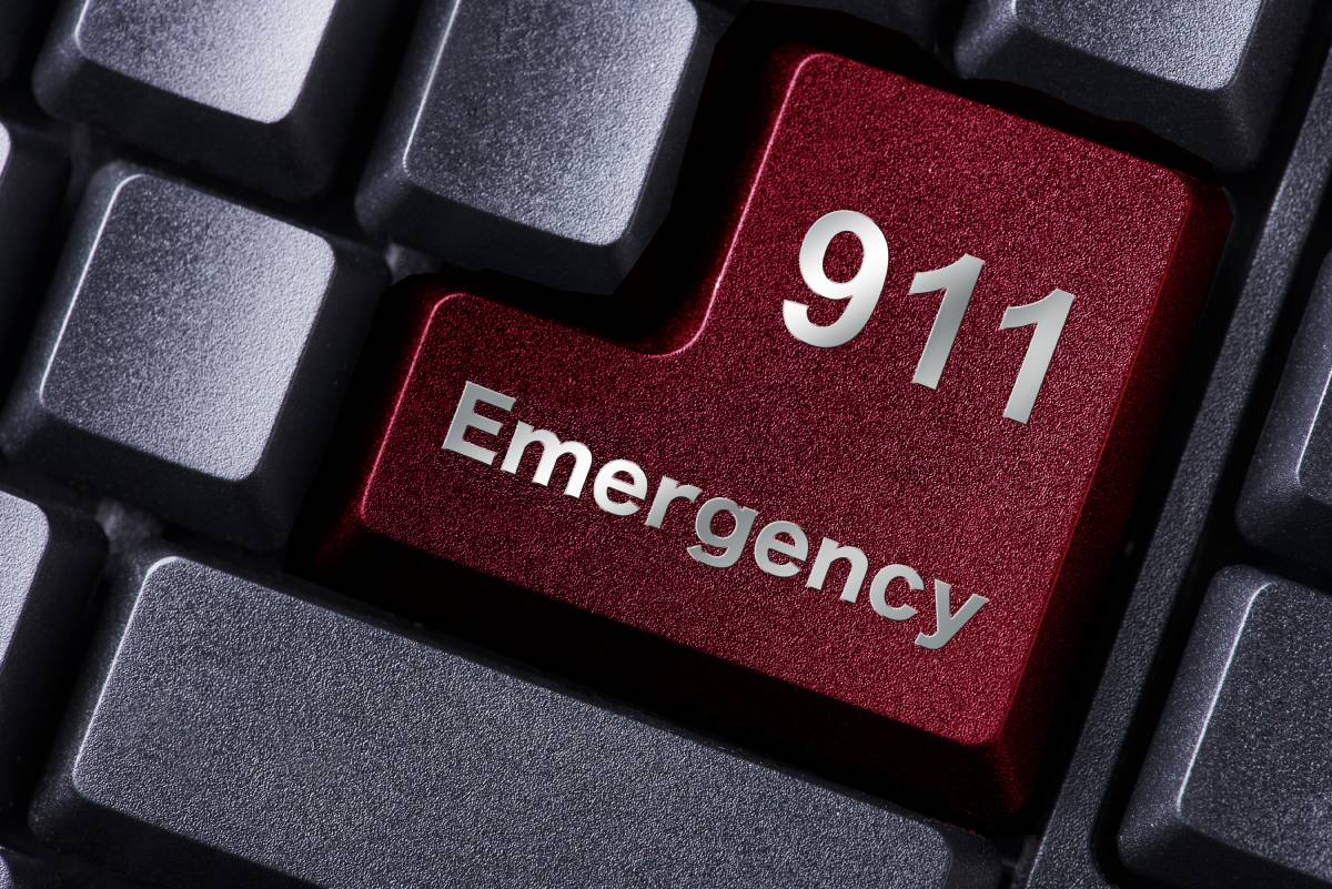 Red key on a keyboard stating 911 Emergency