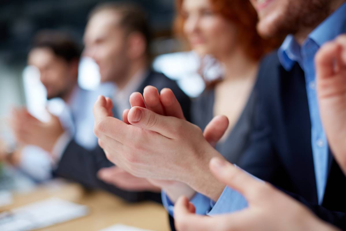 Businessmen and women clapping